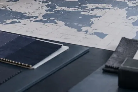 Maps, sourcing documents and material samples arranged on a strategy table